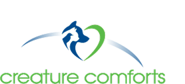 Logo for Creature Comforts featuring a blue dog and green cat forming a heart shape, with the text creature comforts in green below the graphic.