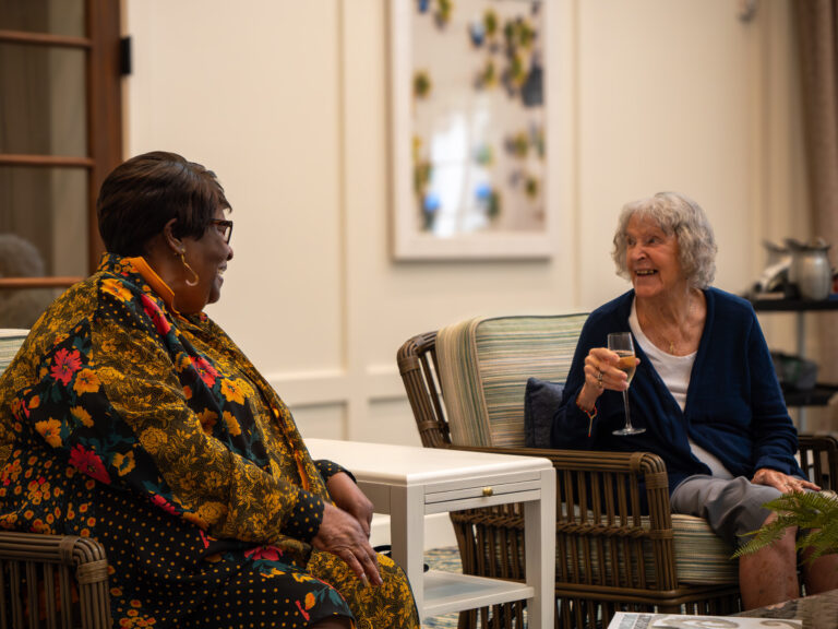 Two seniors smiling at The Glades at ChampionsGate community
