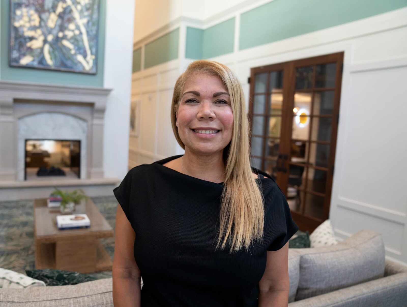 Smiling woman in the common area of The Glades at Championsgate