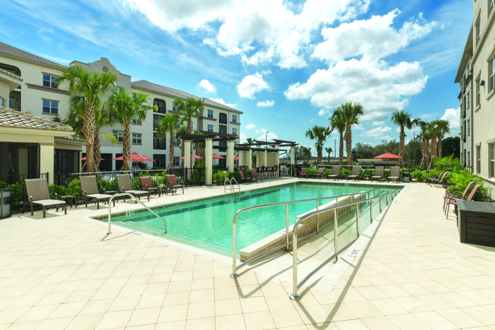 Glades at Championsgate Pool with Palm Trees on a Sunny Day
