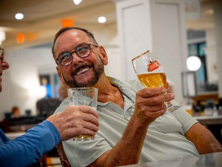 Male residents enjoying a beer at The Glades at Championsgate.